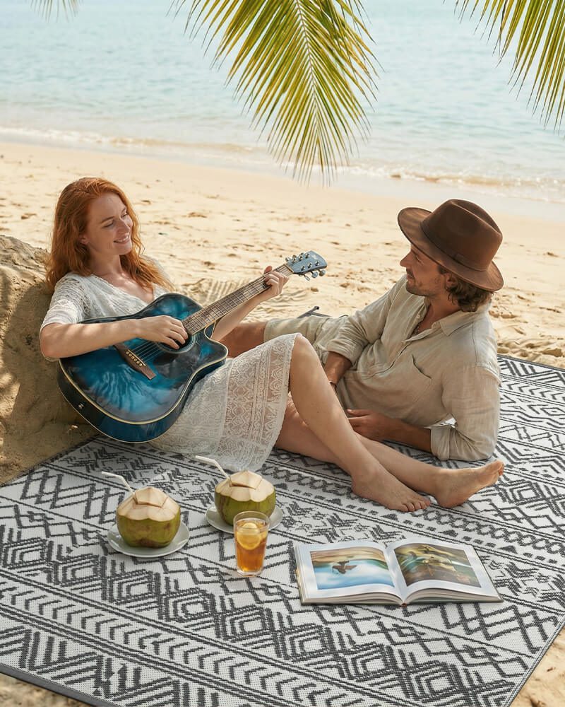 boho-plastic-straw-outdoor-rug-gray-on-a-beach