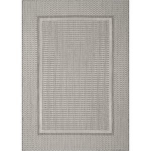 A gray woven indoor outdoor rug features a durable jute-look texture and subtle border design, adding easy-care style to patios, porches, sunrooms, dining areas, and high-traffic living spaces.
