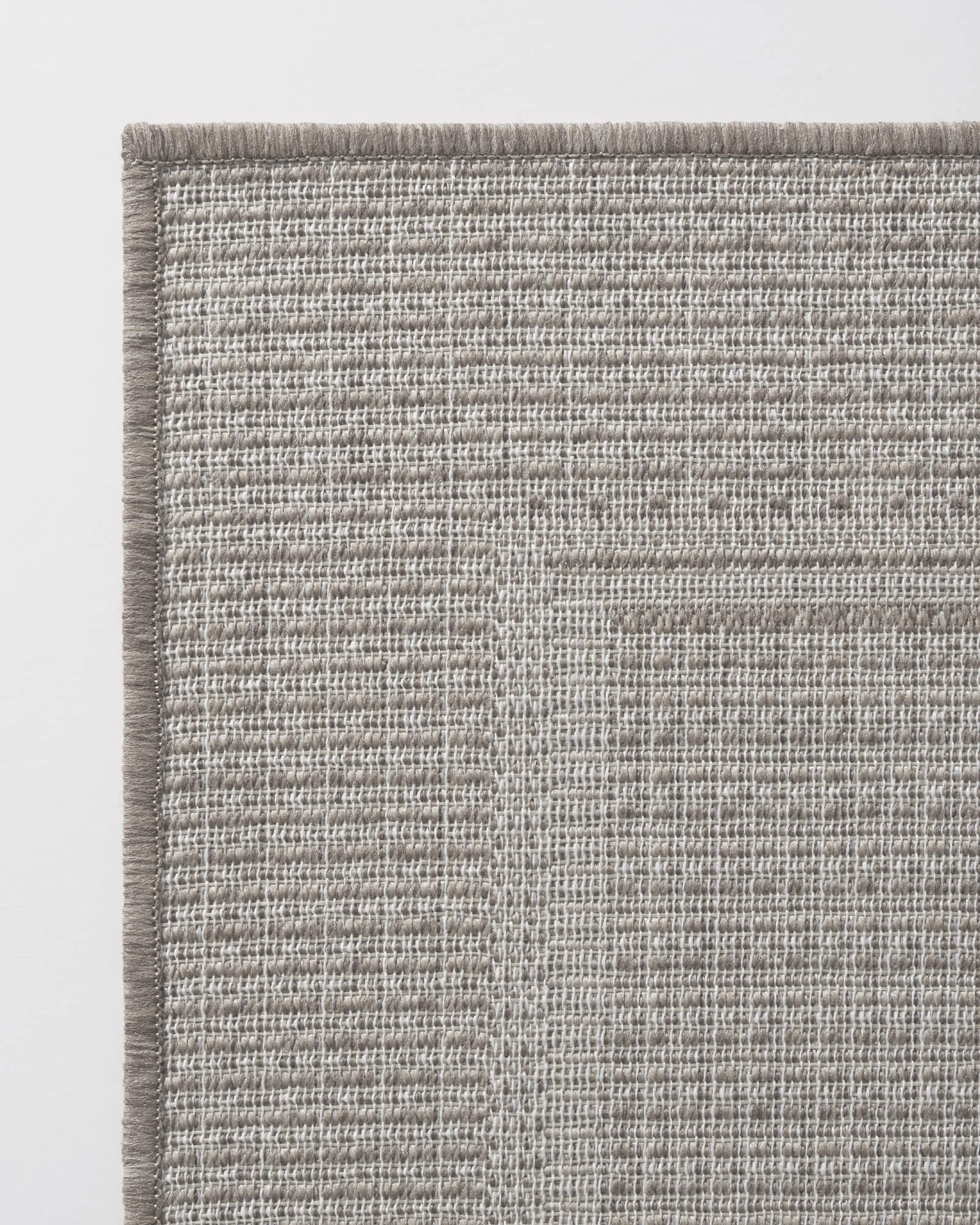 gray-woven-indoor-outdoor-rug-with-reinforced-border-edge