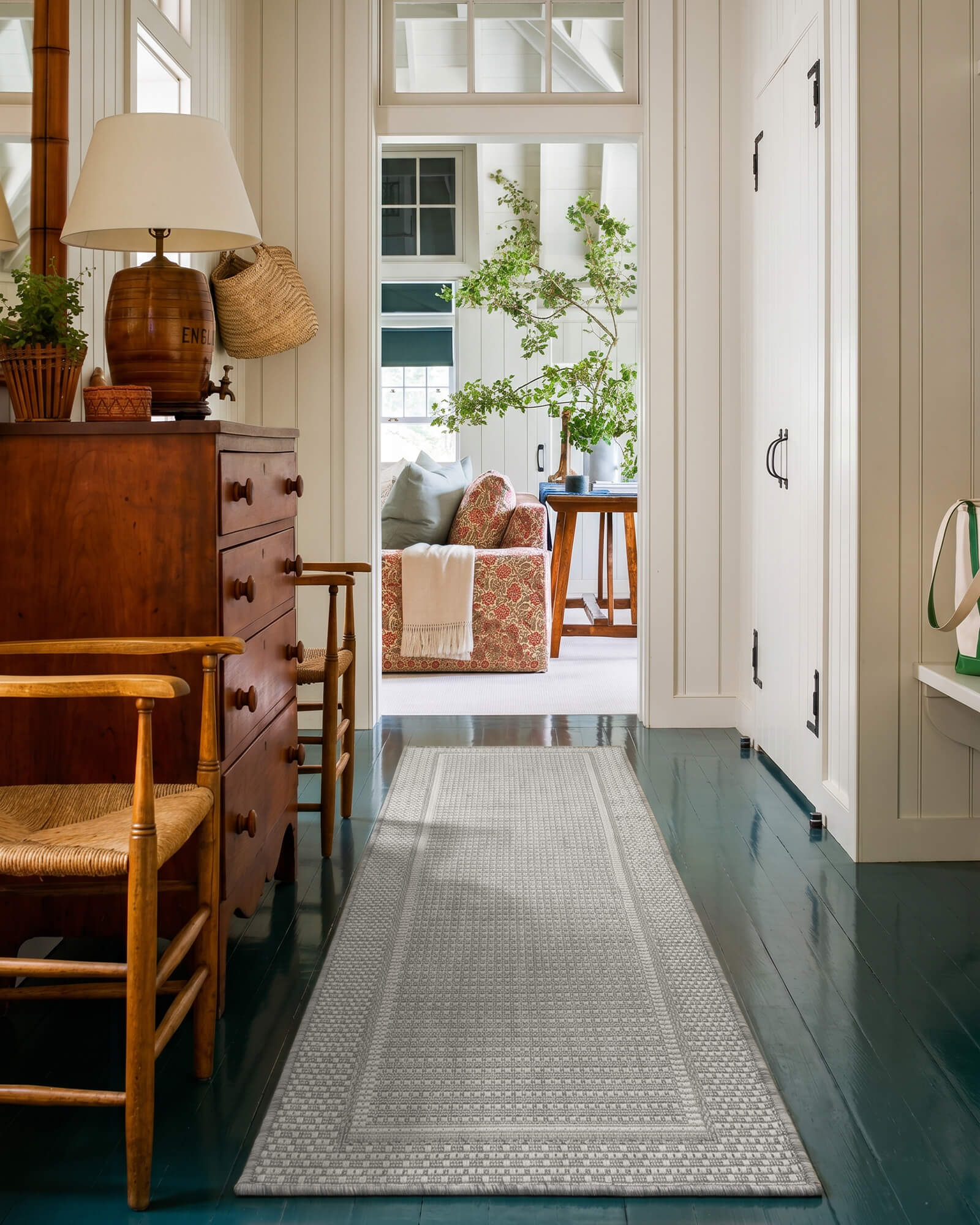 gray-woven-indoor-outdoor-runner-rug-for-hallway-entryway A gray woven indoor outdoor runner rug adds durable jute-look texture and easy-care style to a hallway or entryway with classic wood furniture, painted floors, and cozy home decor.